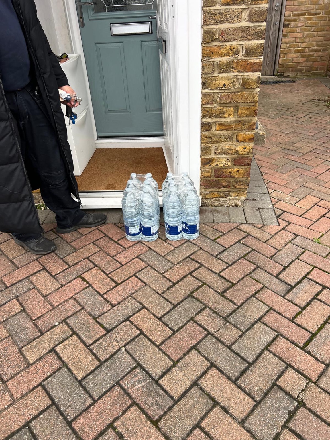 Forklift loading bottled water into a delivery van